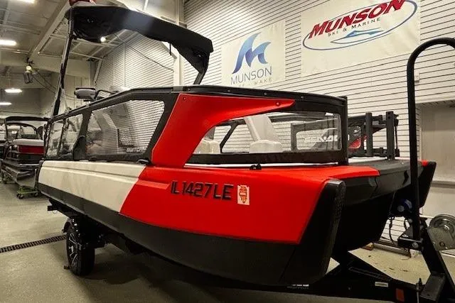Slide: The Image of 2022 Sea-Doo Switch Cruise 21 pontoon boat in showroom, red and black design. - 27