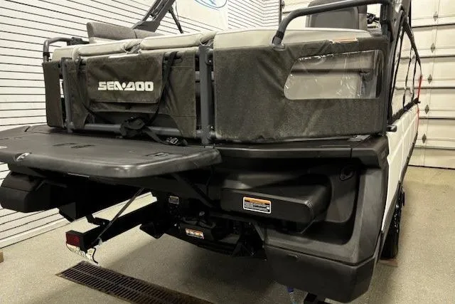 Slide: The Image of 2022 Sea-Doo Switch Cruise 21 pontoon boat rear view in a garage setting. - 29