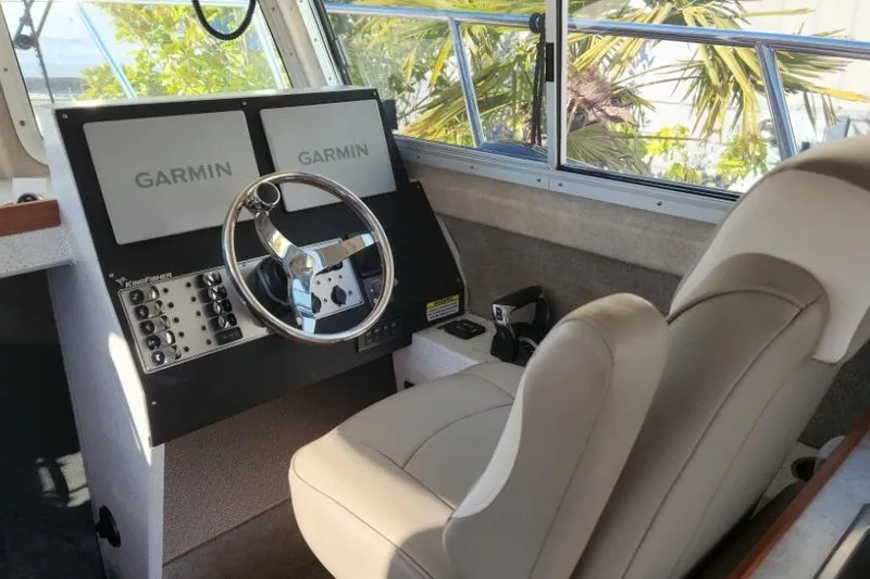 Slide: The Image of 2023 KingFisher 3025 Destination boat cockpit with Garmin navigation displays. - 12