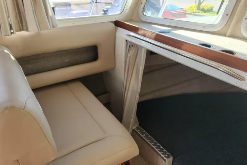 Slide: The Image of Interior of 2023 KingFisher 3025 Destination boat with beige seating and window view. - 14