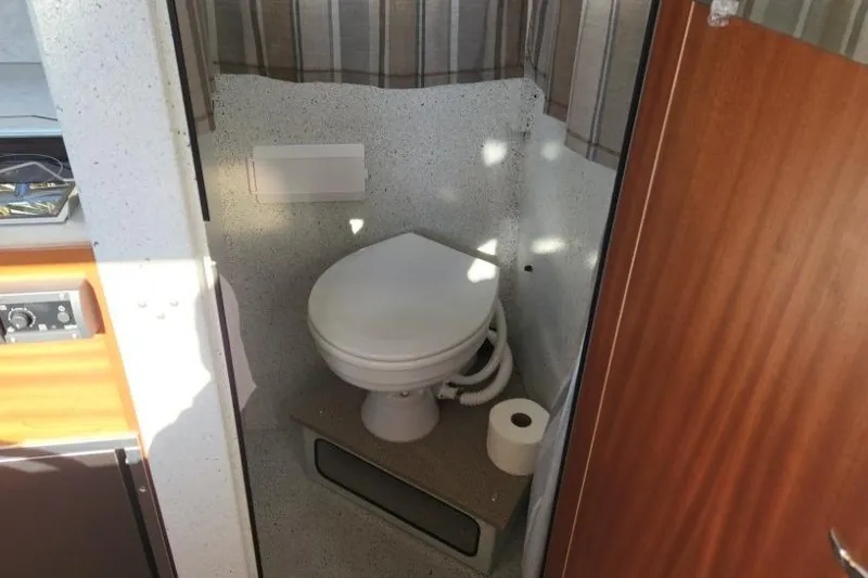 Slide: The Image of Compact bathroom in 2023 KingFisher 3025 Destination boat with toilet and toilet paper. - 19