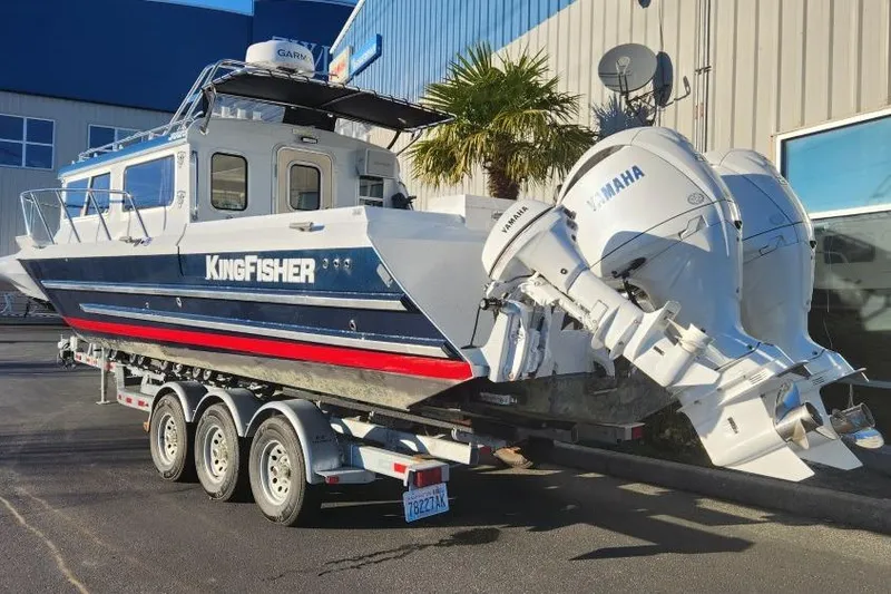 Slide: The Image of 2023 KingFisher 3025 Destination boat on trailer with Yamaha engines, parked outdoors. - 4