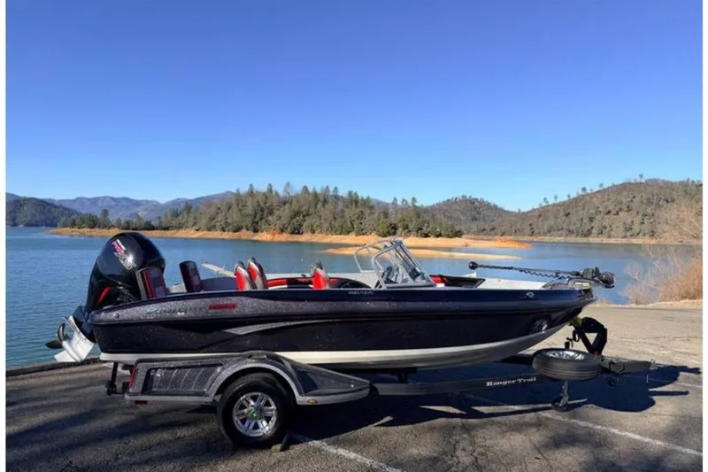 Slide: The Image of 2023 Ranger 1850MS boat on trailer by scenic lake and mountains. - 44