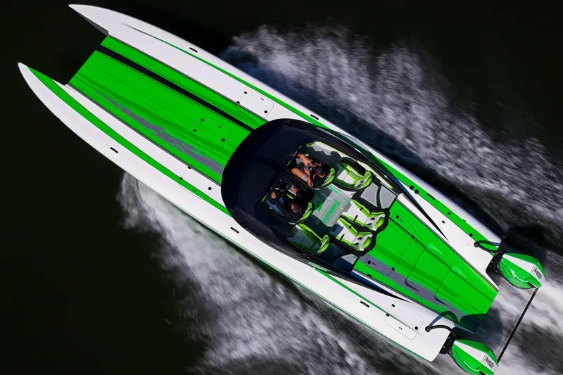 The Image of 2025 Performance Powerboats P360 speeding on water, vibrant green and white design. - 0