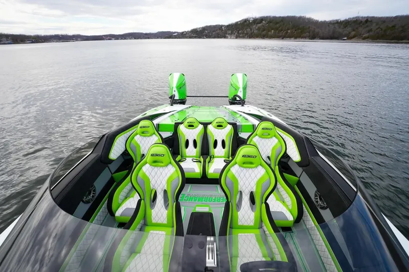 Slide: The Image of 2025 Performance Powerboats P360 with vibrant green seats on a serene lake. - 3