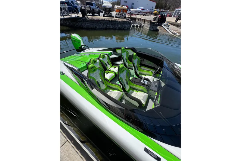 Slide: The Image of 2025 Performance Powerboats P360 with vibrant green interior, docked at a marina. - 8