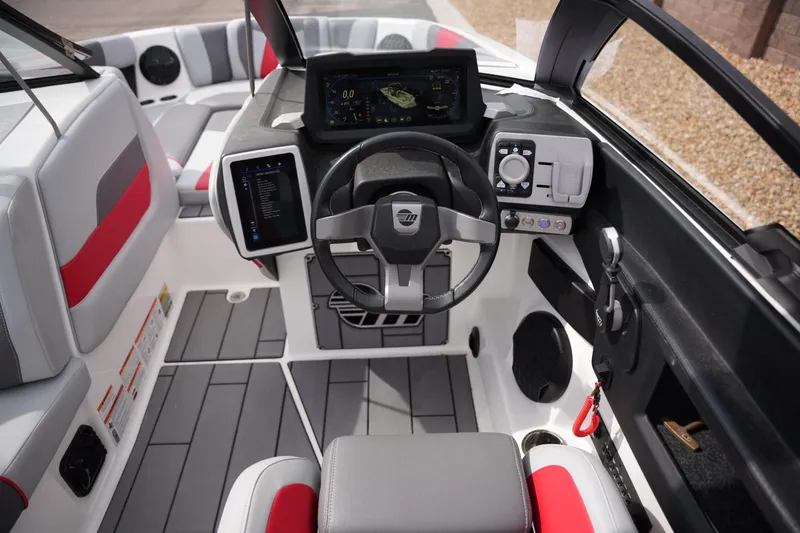 Slide: The Image of 2022 Malibu Wakesetter 23 MXZ boat cockpit with modern controls and sleek design. - 11