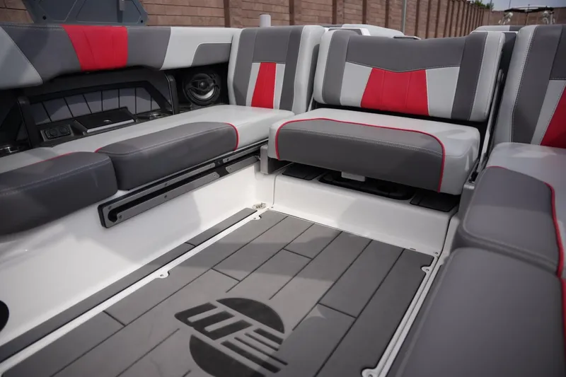 Slide: The Image of Interior seating of 2022 Malibu Wakesetter 23 MXZ boat, featuring gray and red upholstery. - 13