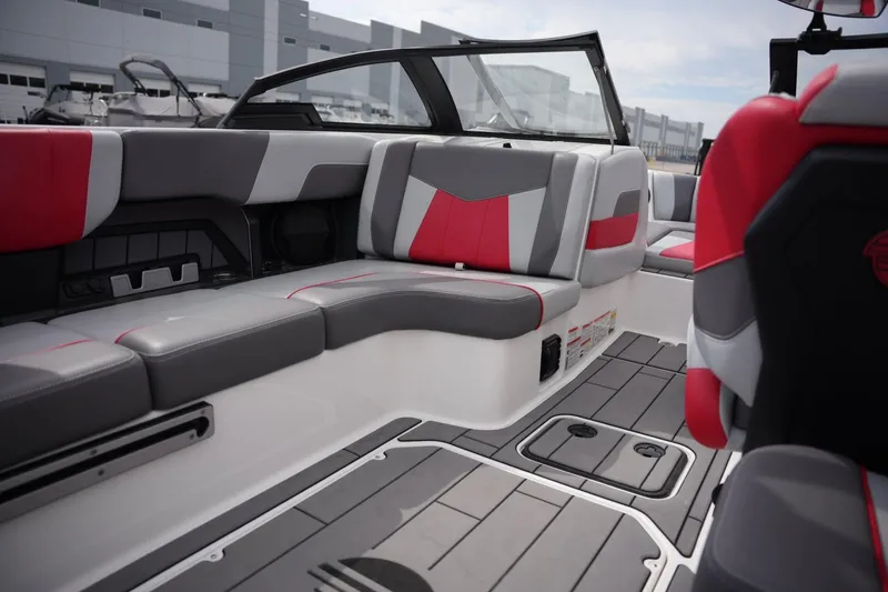 Slide: The Image of 2022 Malibu Wakesetter 23 MXZ interior with red and gray seating, modern design. - 15