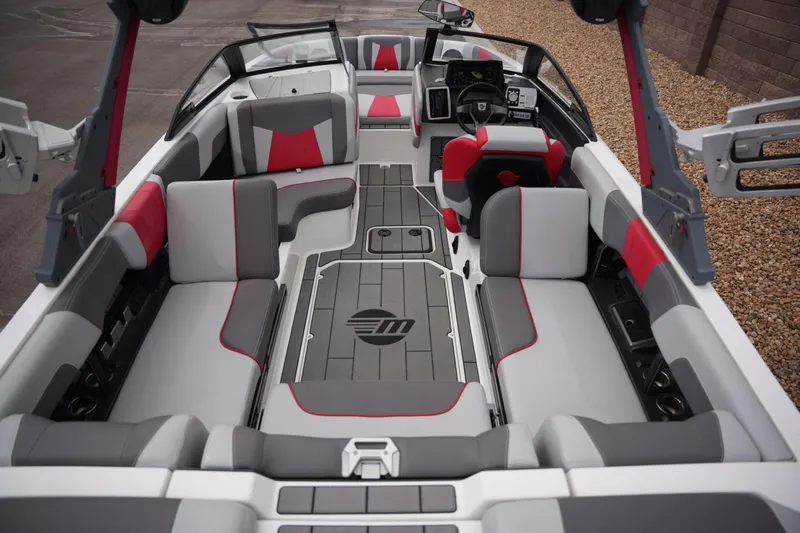 Slide: The Image of 2022 Malibu Wakesetter 23 MXZ interior with gray and red seating, modern dashboard. - 16