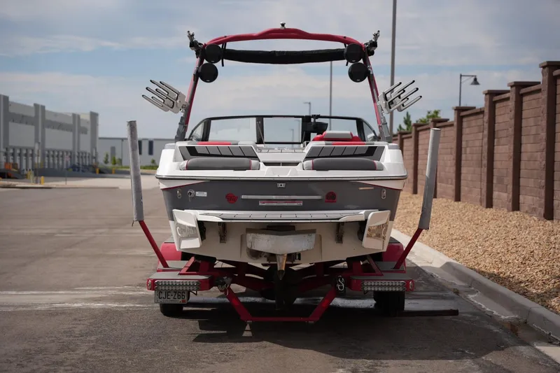 Slide: The Image of 2022 Malibu Wakesetter 23 MXZ boat on trailer, parked in urban area. - 3