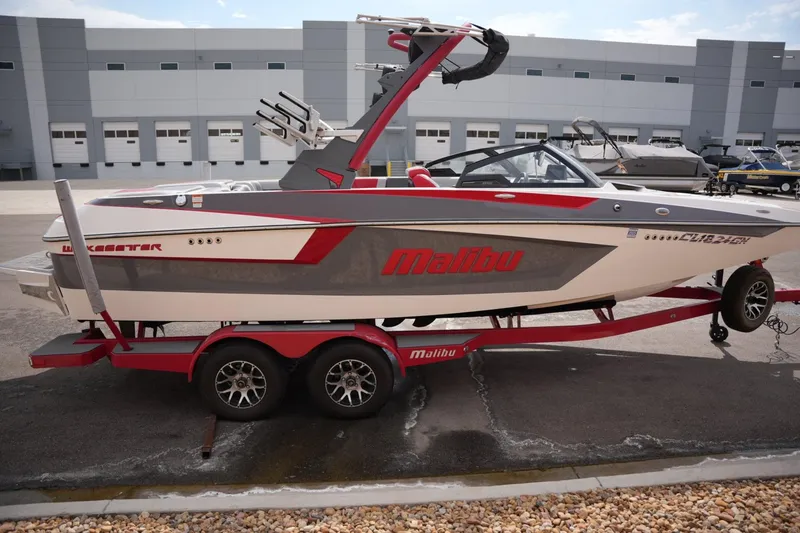 Slide: The Image of 2022 Malibu Wakesetter 23 MXZ boat on trailer, parked outside a warehouse. - 5