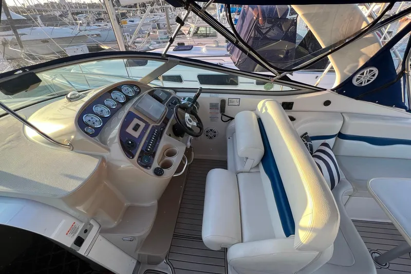 Slide: The Image of 2003 Chaparral Signature 320 boat interior with helm, gauges, and seating area. - 12