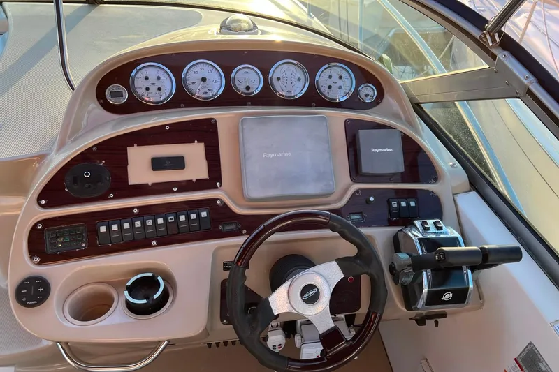 Slide: The Image of 2003 Chaparral Signature 320 boat dashboard with steering wheel and control panel. - 13