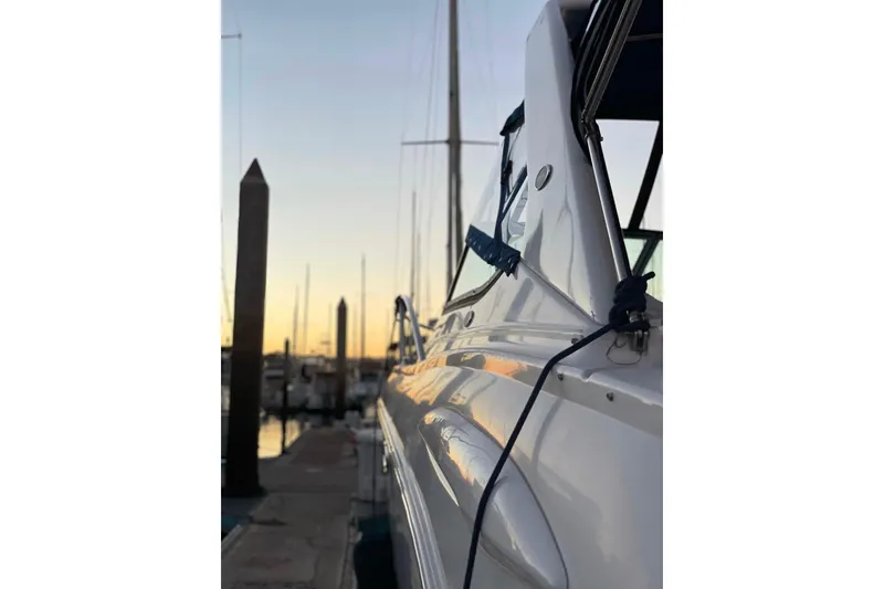 Slide: The Image of 2003 Chaparral Signature 320 yacht docked at sunset, side view. - 14