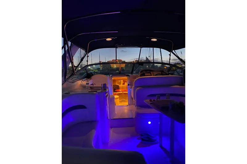 Slide: The Image of 2003 Chaparral Signature 320 boat interior with ambient blue lighting at dusk. - 15