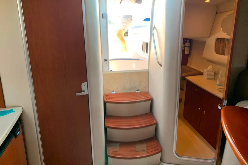 Slide: The Image of Interior of 2003 Chaparral Signature 320 yacht with wooden steps and cabin amenities. - 17