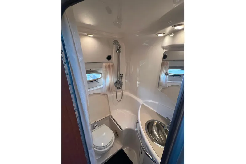 Slide: The Image of 2003 Chaparral Signature 320 bathroom with shower, sink, and toilet. - 18