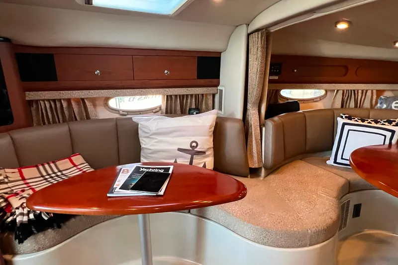Slide: The Image of Interior of 2003 Chaparral Signature 320 yacht with cozy seating and nautical decor. - 8