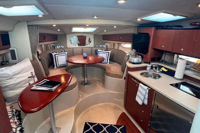 Slide: The Image of Interior of 2003 Chaparral Signature 320 yacht with cozy seating and kitchenette. - 9