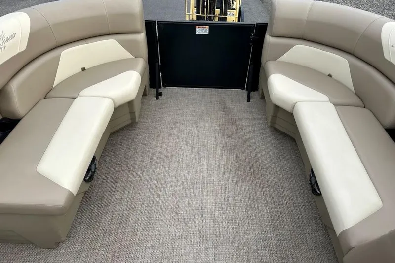 Slide: The Image of 2024 SunChaser Geneva Cruise 20 LR DH interior with beige seating and carpeted floor. - 10