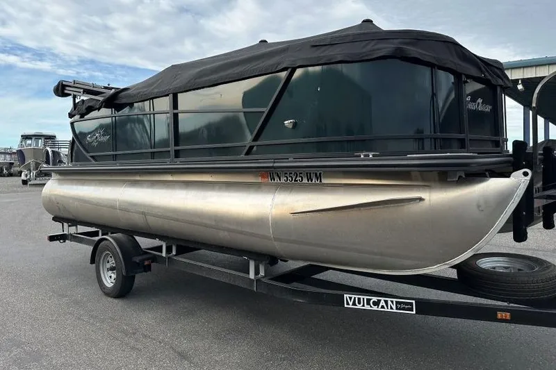 Slide: The Image of 2024 SunChaser Geneva Cruise 20 LR DH pontoon boat on trailer, covered and parked outdoors. - 3
