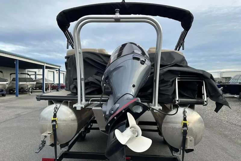 Slide: The Image of 2024 SunChaser Geneva Cruise 20 LR DH pontoon boat with outboard motor, docked outdoors. - 5