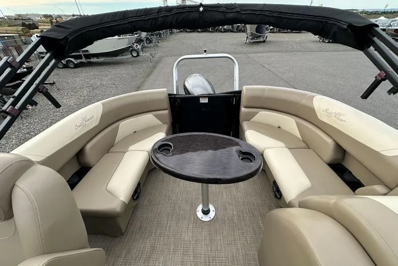 Slide: The Image of 2024 SunChaser Geneva Cruise 20 LR DH pontoon boat interior with seating and table. - 7