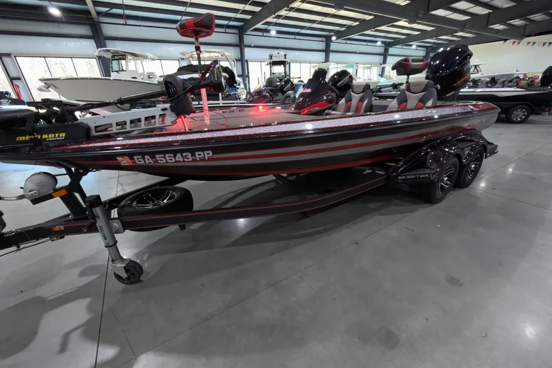 The Image of 2017 Skeeter FX20 bass boat in showroom, featuring red and gray design. - 1