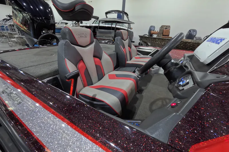 Slide: The Image of 2017 Skeeter FX20 boat interior with red and gray seating, steering wheel, and dashboard. - 10