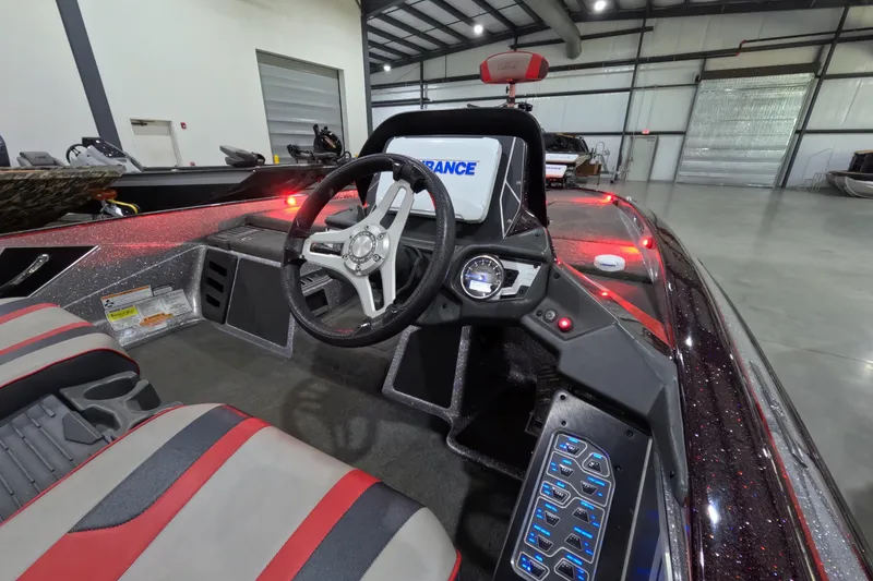 Slide: The Image of 2017 Skeeter FX20 boat interior with steering wheel and control panel in a spacious garage. - 11