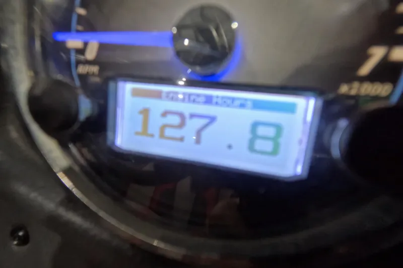 Slide: The Image of Close-up of 2017 Skeeter FX20 gauge displaying 127.8 hours. - 12