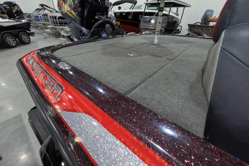 Slide: The Image of 2017 Skeeter FX20 boat with glittery red and silver detailing, showcased indoors. - 13