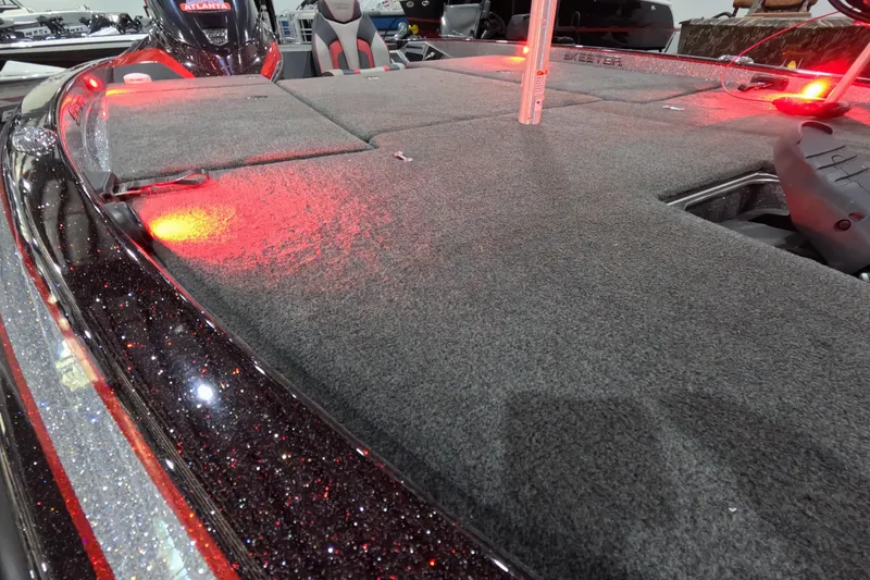 Slide: The Image of 2017 Skeeter FX20 boat deck with red lighting and carpeted surface. - 8