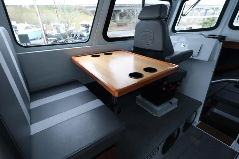 Slide: The Image of 2024 Hewescraft 270 Pacific Explorer ET Hardtop interior with seating and table. - 11