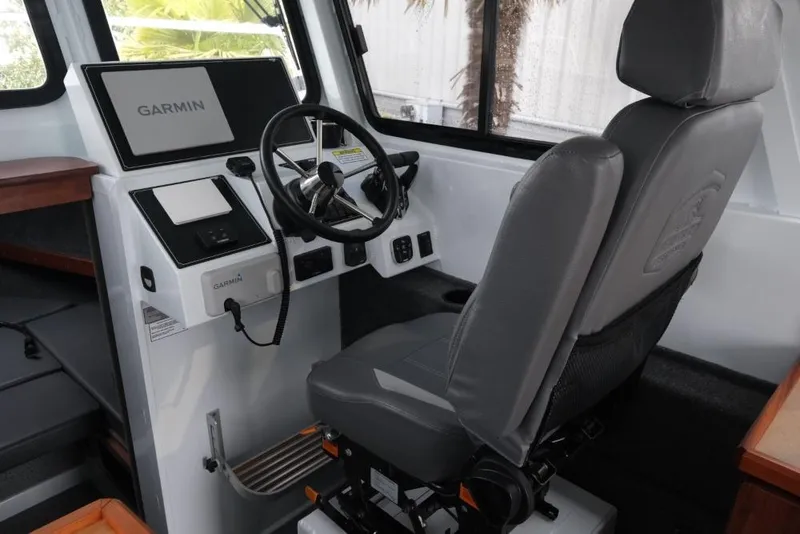 Slide: The Image of 2024 Hewescraft 270 Pacific Explorer ET Hardtop helm with Garmin navigation system. - 12