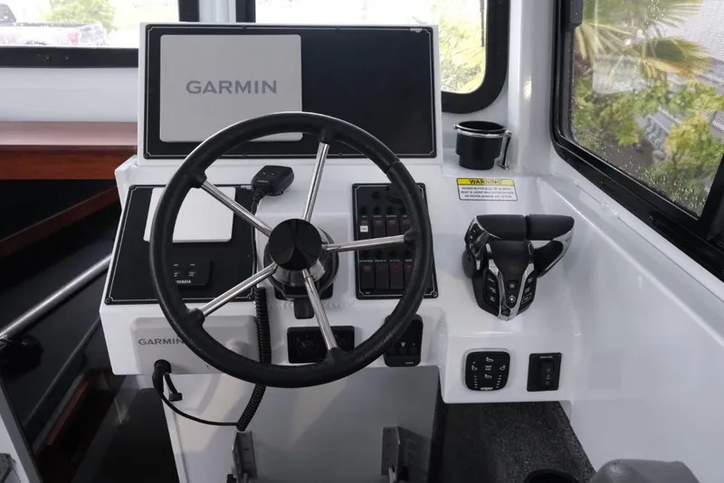 Slide: The Image of 2024 Hewescraft 270 Pacific Explorer ET Hardtop helm with Garmin navigation system. - 13