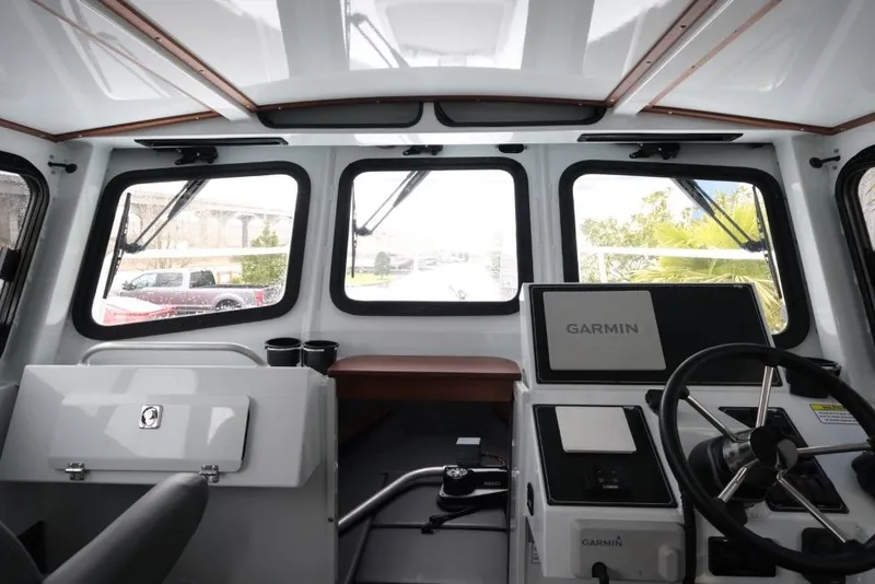 Slide: The Image of Interior view of 2024 Hewescraft 270 Pacific Explorer ET Hardtop boat cockpit. - 14