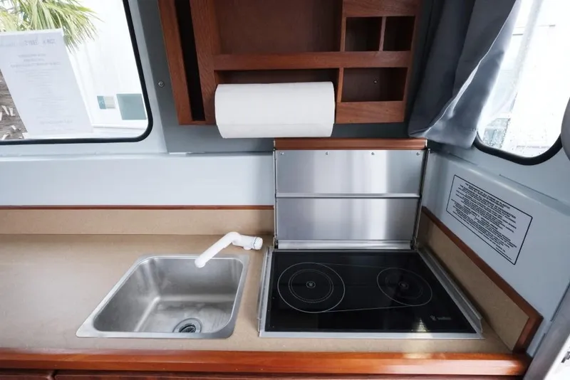 Slide: The Image of 2024 Hewescraft 270 Pacific Explorer ET Hardtop kitchen with sink and electric stove. - 18