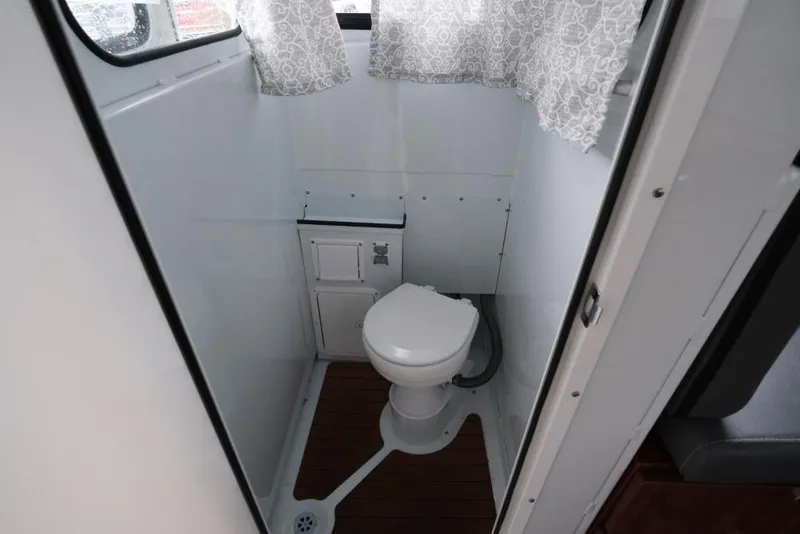 Slide: The Image of Compact bathroom in 2024 Hewescraft 270 Pacific Explorer ET Hardtop boat. - 19