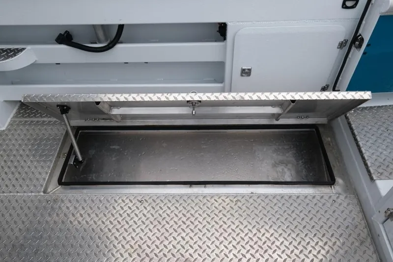 Slide: The Image of 2024 Hewescraft 270 Pacific Explorer ET Hardtop storage compartment with diamond plate flooring. - 23