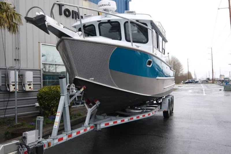 Slide: The Image of 2024 Hewescraft 270 Pacific Explorer ET Hardtop on trailer, parked outside a building. - 3