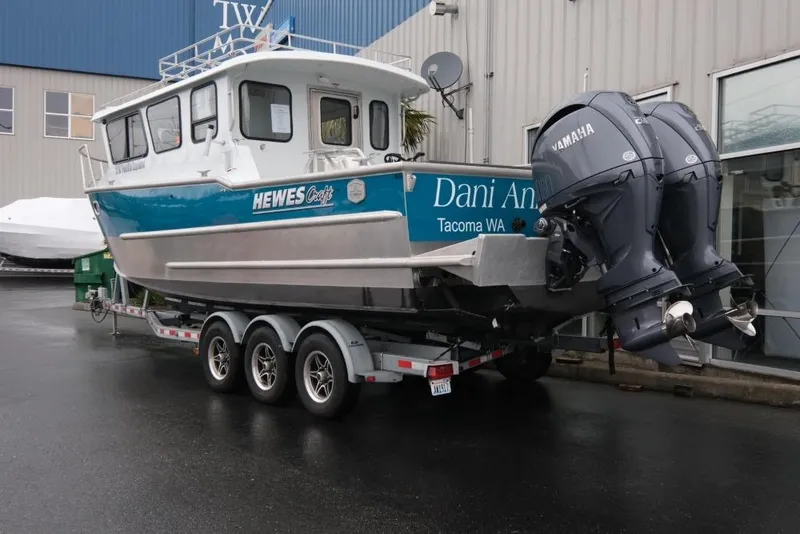 Slide: The Image of 2024 Hewescraft 270 Pacific Explorer ET Hardtop boat on trailer, dual Yamaha engines. - 4