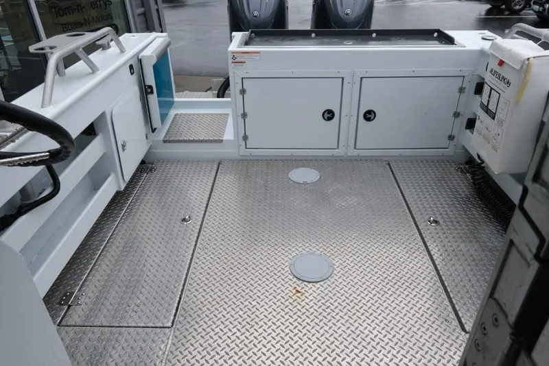 Slide: The Image of 2024 Hewescraft 270 Pacific Explorer ET Hardtop boat deck with storage compartments. - 9
