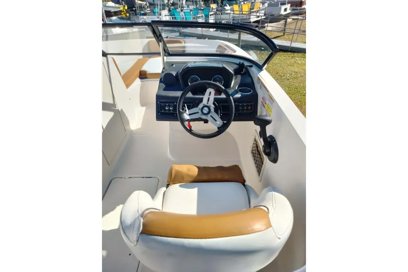 Slide: The Image of 2022 Bayliner VR6 Bowrider OB cockpit with steering wheel and seating. - 13
