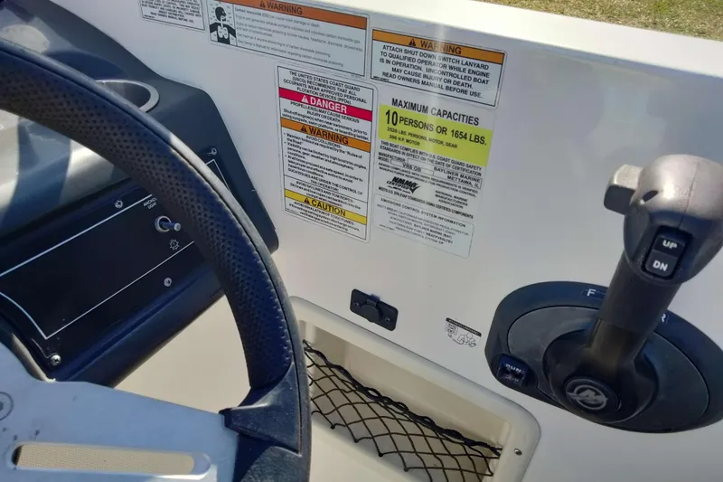 Slide: The Image of 2022 Bayliner VR6 Bowrider OB dashboard with steering wheel and control panel. - 14