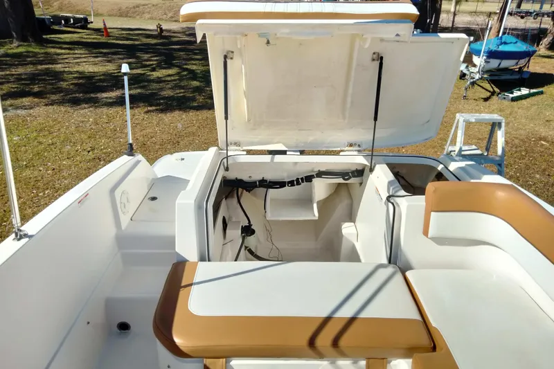 Slide: The Image of 2022 Bayliner VR6 Bowrider OB interior storage compartment with open hatch. - 19