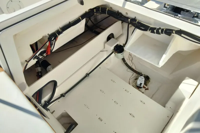 Slide: The Image of 2022 Bayliner VR6 Bowrider OB engine compartment with wiring and components visible. - 21