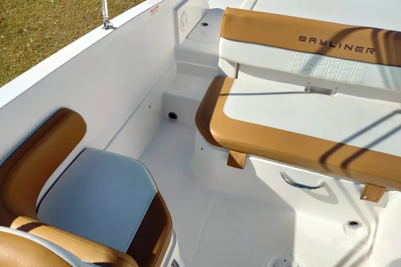Slide: The Image of 2022 Bayliner VR6 Bowrider OB interior with tan and white seating. - 22