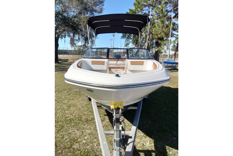 Slide: The Image of 2022 Bayliner VR6 Bowrider OB on trailer, parked outdoors under a canopy. - 27